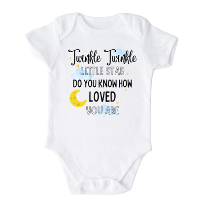 A kids' t-shirt with a captivating night sky graphic adorned with stars and a moon cup. The text reads 'Twinkle Twinkle Little Star, Do You Know How Loved You Are?' The design embodies a sense of magic, love, and wonder, inspiring imagination and admiration.