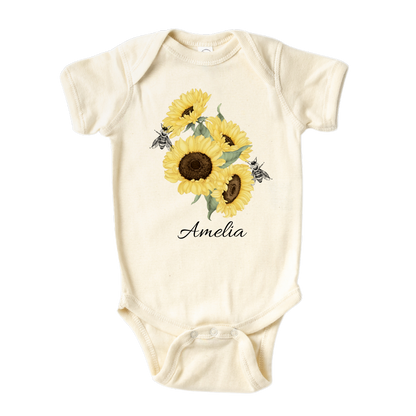 Baby Onesie A kid's t-shirt with a cute printed graphic of sunflowers and bees, personalized with a customized name. This delightful tee is stylish, comfortable, and made from high-quality materials. 