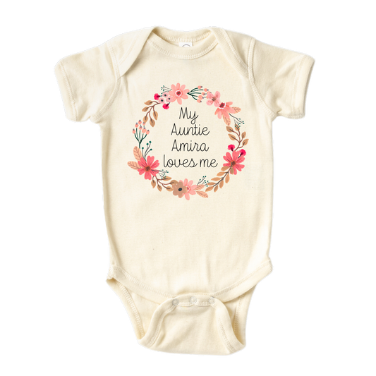 Natural Baby Onesie featuring a floral wreath design and customizable text 'My Auntie Loves Me.