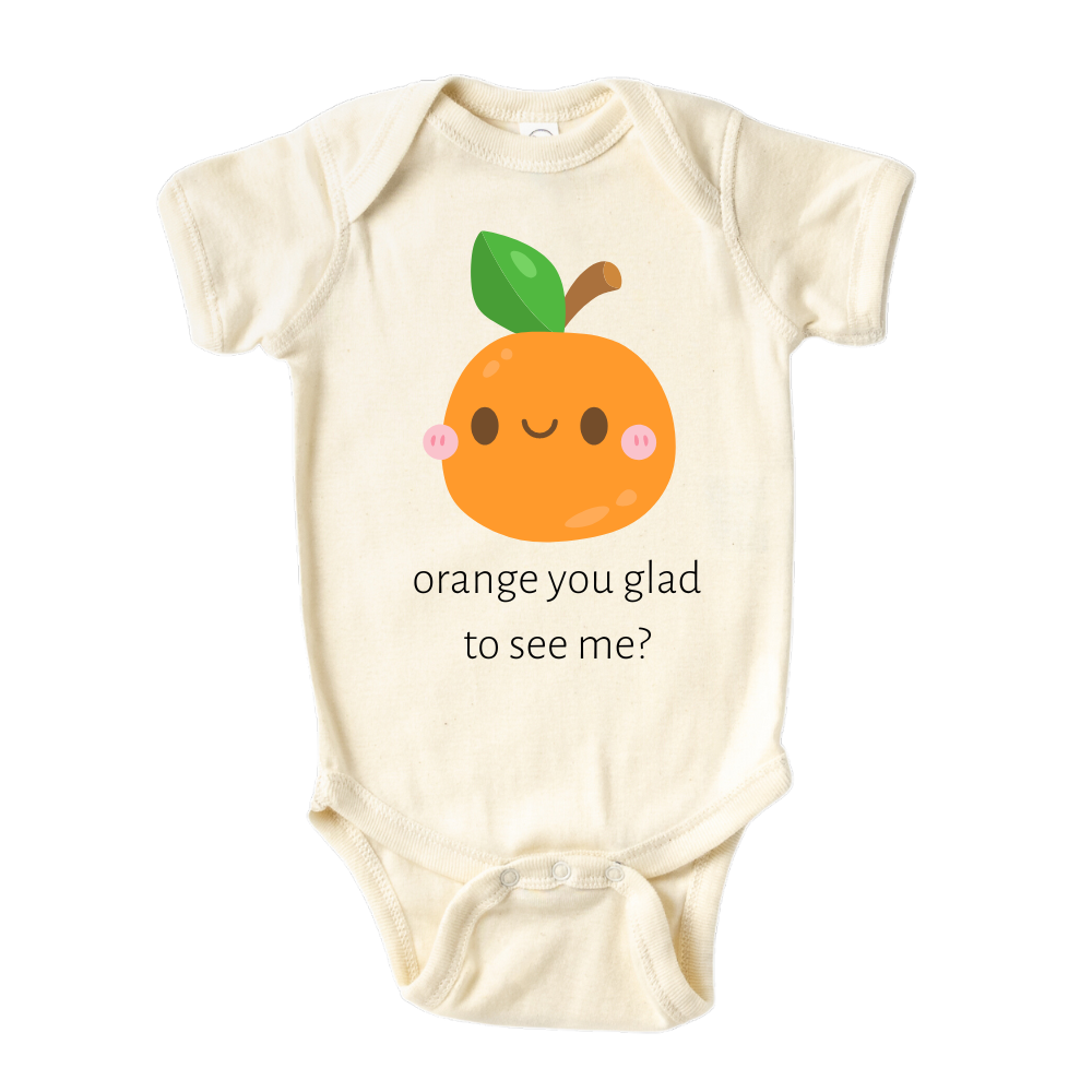 A kids' t-shirt with a charming graphic of a cute orange and the text 'Orange You Glad To See Me.' The design exudes a playful and lighthearted vibe, encouraging positivity and cheerful interactions. It's a delightful and expressive tee that brings joy to those who see it.