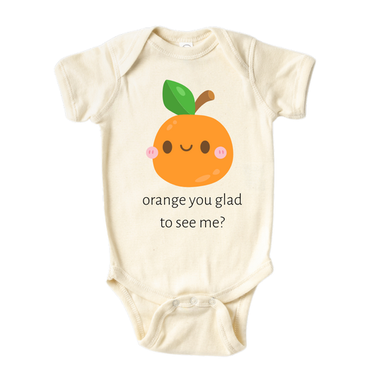 A kids' t-shirt with a charming graphic of a cute orange and the text 'Orange You Glad To See Me.' The design exudes a playful and lighthearted vibe, encouraging positivity and cheerful interactions. It's a delightful and expressive tee that brings joy to those who see it.