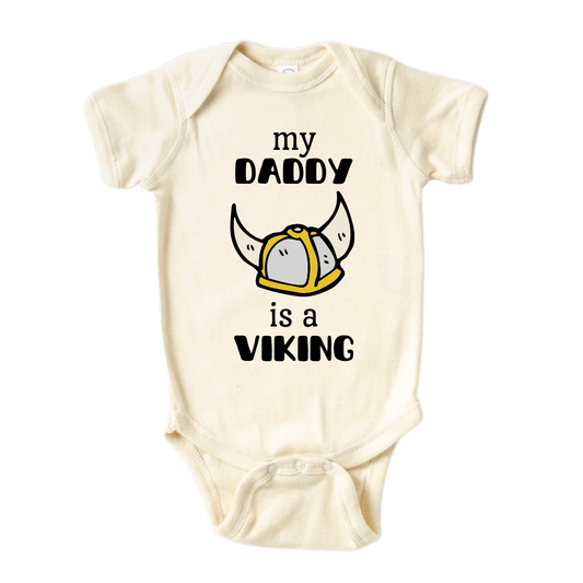 Natural Onesie with a printed graphic of the text 'My daddy is a viking.' This playful design celebrates the strong bond between a child and their Viking dad.