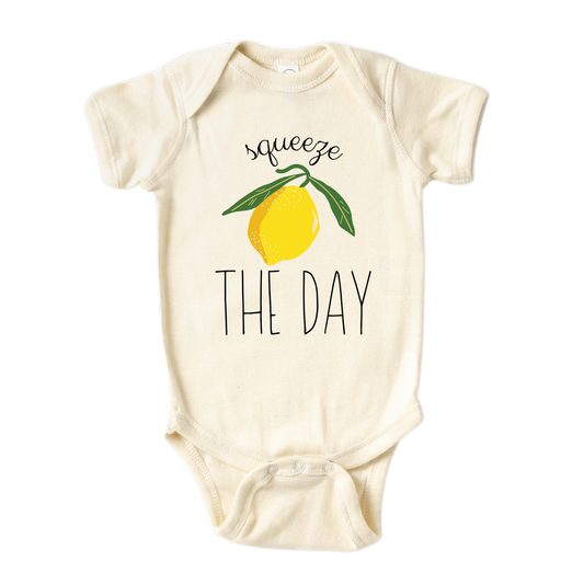 Natural Short Sleeve Baby Bodysuit with a cute lemon graphic and the text 'Squeeze The Day.' This vibrant design encourages seizing opportunities and embracing positivity