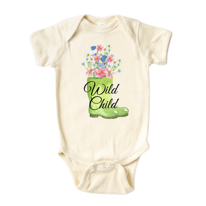 A kids' t-shirt with a whimsical graphic of a green boot adorned with blooming flowers inside. The text reads 'Wild Child,' capturing the essence of a free-spirited and adventurous nature. The design symbolizes the beauty and vitality found in embracing the wild side of life.