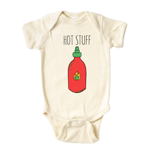 Natural Onesie showcasing an adorable printed graphic of a chili bottle and the bold text 'Hot Stuff.' Elevate your child's style with this trendy and playful tee. 