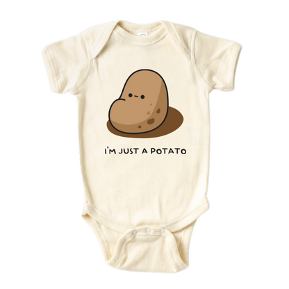 Natural Baby Bodysuit showcasing a playful printed graphic of a potato and the text 'I'm just a potato.' Explore this adorable tee that celebrates uniqueness and humor.