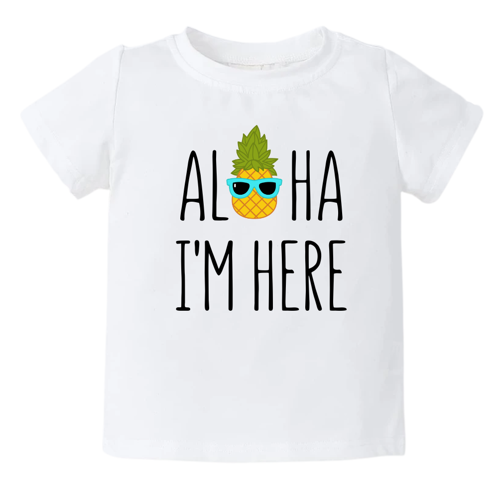 A kids' t-shirt with a pineapple wearing glasses and the text 'Aloha I'm Here.' This fun and tropical design captures the playful spirit, adding a vibrant touch to the wearer's style.