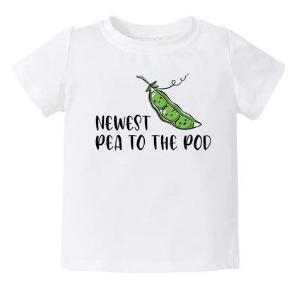 White Short Sleeve Kid Tshirt with a pea icon and the text 'Newest Pea to The Pod.' This adorable design symbolizes the arrival of a new family member, capturing the joy and excitement. Celebrate your little one with this cute and stylish tee.