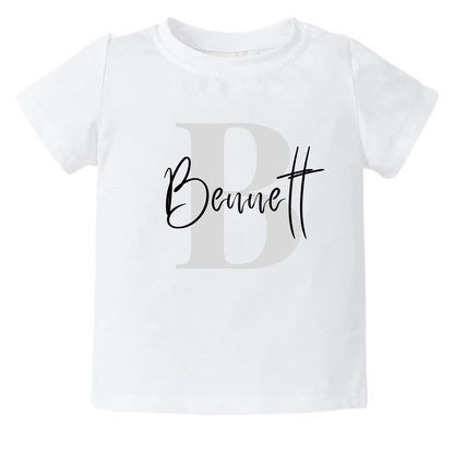 Kid Tshirt with grey initial design and customizable name.