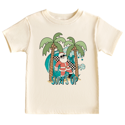 Kids' t-shirt with a funny Santa surfing graphic and the text 'Surf's Up' - perfect for adding some holiday cheer and beach vibes to their outfit.