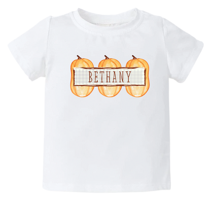 Kid's t-shirt with a cute pumpkin frame design, customizable with names.