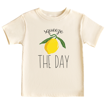 Natural Short Sleeve Kid Tshirt with a cute lemon graphic and the text 'Squeeze The Day.' This vibrant design encourages seizing opportunities and embracing positivity