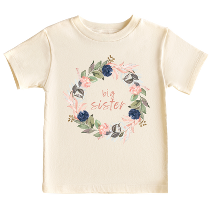 A kid's t-shirt with a cute printed graphic of a floral wreath and the text 'Big Sister.' This adorable t-shirt celebrates the special role of being a big sister. Made with high-quality materials, it offers comfort and durability, making it a perfect addition to any child's wardrobe.