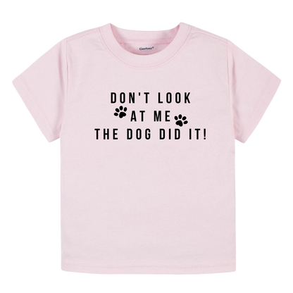 Image of baby onesie and children's t-shirt with the playful text 'The Dog Did It.' Adorable and humorous apparel for kids, perfect for playdates and family outings