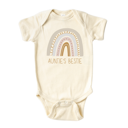 A colorful baby onesie adorned with a delightful printed graphic of a radiant rainbow and the text 'Auntie's Bestie.' This charming tee celebrates the cherished bond between a beloved aunt and her adored niece or nephew.