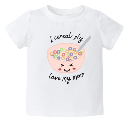 Cute cereal bowl graphic print with customizable text - 'I Cereal-sly Love My Mom' on a kid t-shirt and baby onesie. High-quality and vibrant design for adorable children's clothing. Perfect gift option to express love for Mom. 