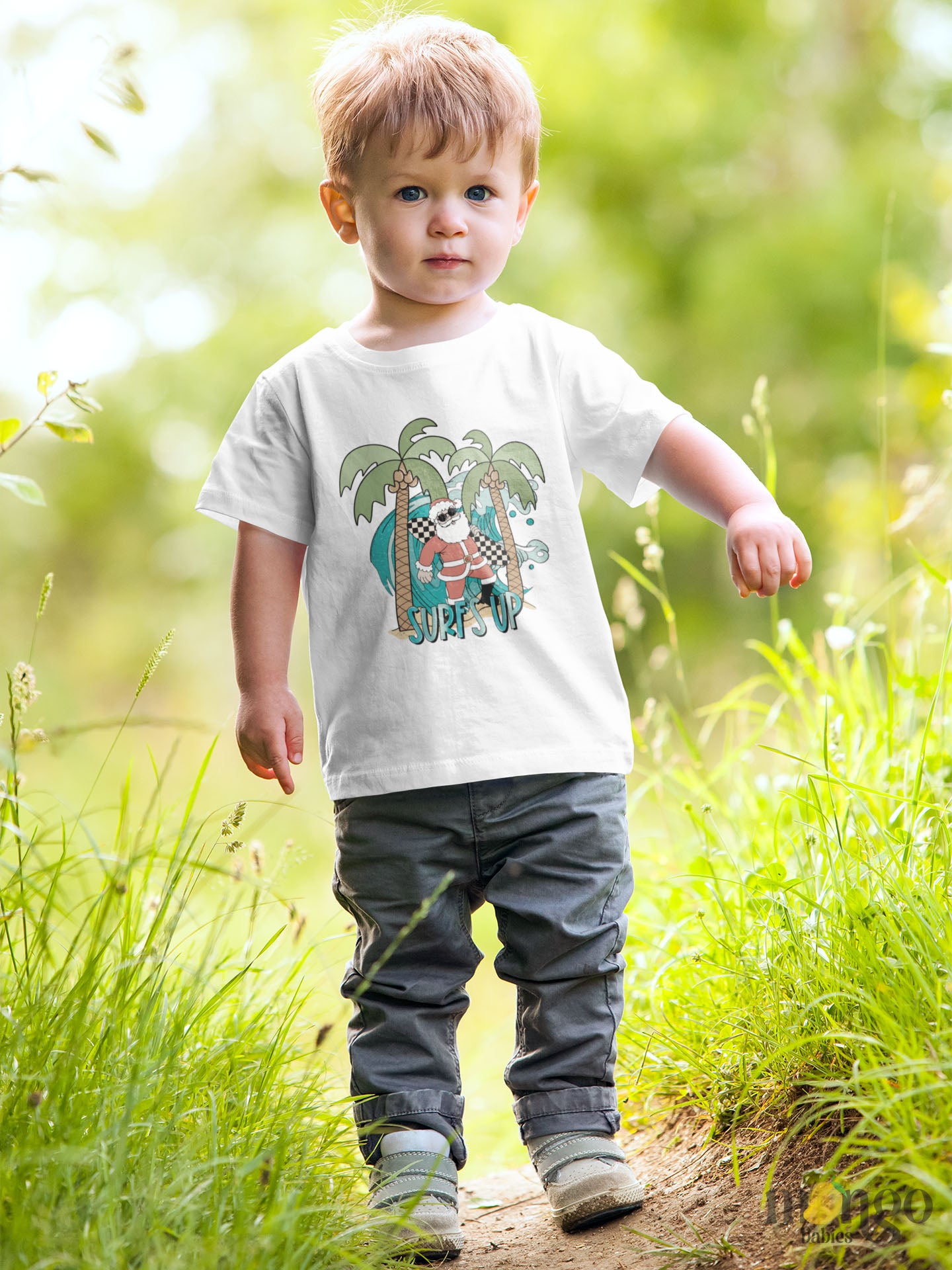 White Kids' t-shirt with a funny Santa surfing graphic and the text 'Surf's Up' - perfect for adding some holiday cheer and beach vibes to their outfit.